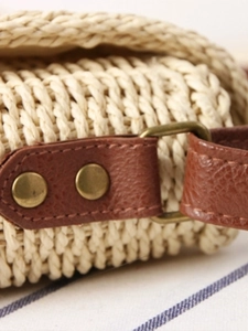Artisanal hand-woven crossbody bag featuring a retro brown leather strap and metal buckle