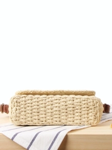 Minimalist straw woven crossbody bag with brown leather strap for beach vacation style
