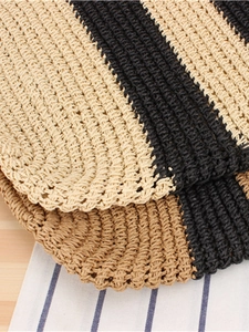 Handcrafted striped paper straw beach bag with elegant woven texture for summer vacation