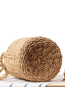 Handwoven paper rope bucket bag with cylindrical base on blue striped cloth background