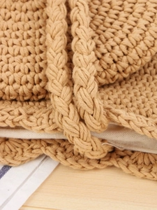 Handmade woven cotton shoulder bag with textured rope handles for beach vacations