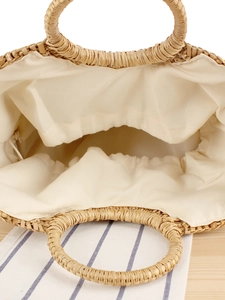 Handcrafted straw tote bag with round handles and fabric lining for summer beach vacations