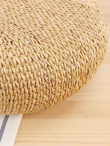 Handcrafted circular straw woven cushion seat with detailed natural fiber texture