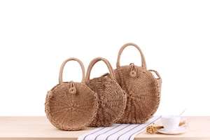 Three-piece set of handmade round paper rope woven beach bags in varying sizes