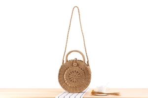 Detailed view of handmade round paper rope woven beach bag with circular weave texture