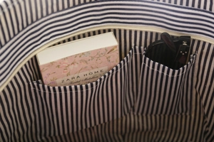 Detail of the blue and white striped fabric lining with two internal storage pockets