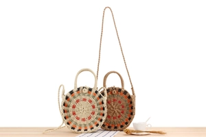 Close-up of handmade round woven beach bags in beige and brown with geometric patterns