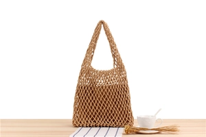 Macro detail of hand-woven beige mesh tote bag with smooth cotton lining and diamond pattern