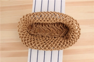 Overhead close-up of handmade beige woven mesh bag featuring interior tassel detail