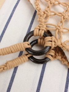 Handmade macrame beach bag with wooden rings and yellow cotton woven texture
