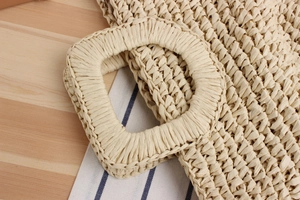Detail of hand-woven paper rope bag showing square handle and intricate crochet texture