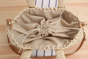 Top view of woven paper rope bag showing interior drawstring lining and leather handles