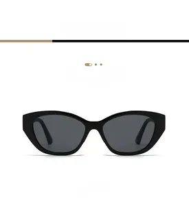Front view detail of glossy black cat-eye sunglasses with gradient grey lenses