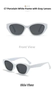 Detail view of cat eye sunglasses featuring porcelain white frames and dark grey lenses