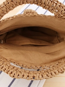 Round handmade woven straw beach bag with inner lining and secure zipper closure
