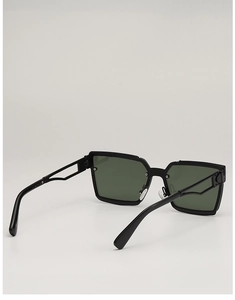 Detail view of square sunglasses with hollowed-out temples and dark green lenses