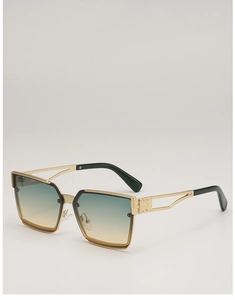 Detail of square gold sunglasses featuring gradient lenses and hollowed-out temples