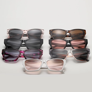 Flat lay of cat-eye sunglasses in various colors including leopard print and transparent grey
