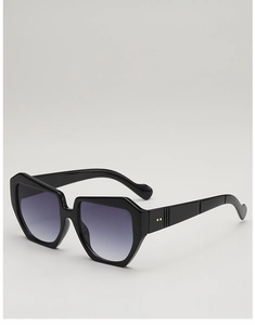 Close-up of thick square sunglasses frame with golden rivet details and gradient lenses
