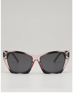 Close-up of pink cat-eye sunglasses with gradient transparent frames and dark lenses