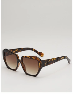 Detail of tortoiseshell square sunglasses with gradient brown lenses and metal rivets
