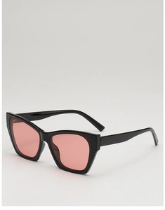Close-up of black cat-eye sunglasses with pink lenses and polished acetate frame detail