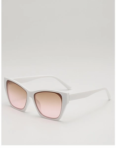 Detail of sleek white cat eye sunglasses with brown gradient lenses and comfortable bridge