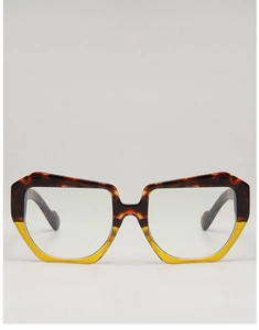Detailed view of square glasses frames with brown tortoiseshell and yellow contrast gradient