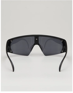 Close-up of oversized one-piece wrap sunglasses with sleek black frame and dark lenses