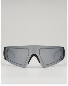 Front view of futuristic oversized sunglasses with grey mirrored lenses and silver rivets