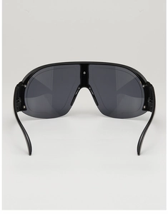 Macro shot of oversized wrap-around sunglasses with wide temples and glossy black frames