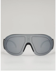Detail of futuristic black shield sunglasses with silver metal rivets and grey lenses