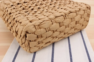Close-up of tight-knit natural fiber straw handbag showing texture and craftsmanship