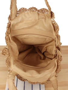 Interior view of straw woven shoulder bag showing fabric lining and zipper pocket