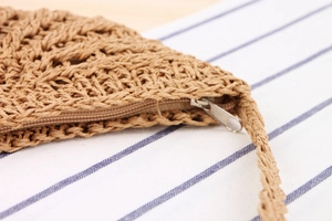 Macro shot of handcrafted straw bag texture with high-quality metal zipper closure details