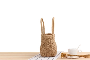 Close-up of handmade straw tote bag texture on wooden table with rustic props