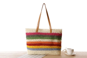 Détail du tissage en corde de papier rayé arc-en-ciel et des poignées en PU marron du sac