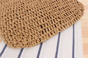 Detailed macro view of handcrafted honeycomb woven texture on a natural straw bag