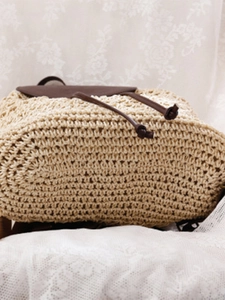 Summer straw rope woven backpack with brown leather flap for beach and leisure vacations