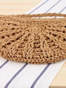 Handmade woven crossbody bag with hollow straw pattern for summer beach vacations