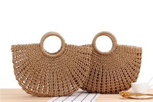 Close-up of handmade paper rope woven beach bags with circular handles and hollow texture
