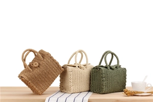 Detailed texture of hand-woven crossbody bags in brown, beige, and olive green