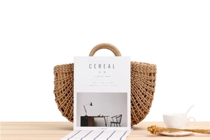 Detail view of hollow woven paper rope beach bag with round handles and fabric lining
