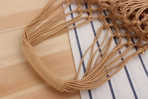 Close-up of handmade woven cotton rope bag showing detailed mesh and reinforced handle