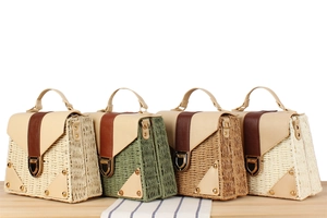 Detailed comparison of four paper straw woven handbags with leather handles and metal locks