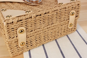 Close-up of woven paper rope bag with reinforced leather corners and metallic rivets