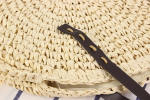 Détail de sac rond tissé en corde de papier montrant la texture et le cuir