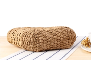 Detailed macro view of the solid cross-weave texture on a retro straw woven shoulder bag