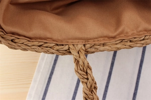 Detail of hand-woven paper rope shoulder bag showing sturdy handles and fabric lining
