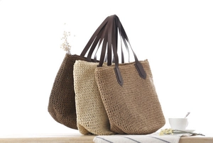 Détail de sacs cabas tissés à la main avec poignées en cuir en trois couleurs assorties